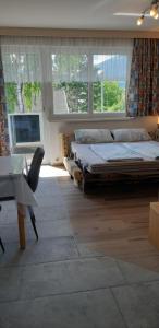 a bedroom with two beds and a desk and a piano at Ferienwohnung Mühlburger in Lienz