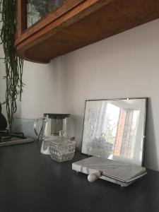 a counter with a blender and a mirror on it at Apartamenty Miły - Gdynia Redłowo in Gdynia