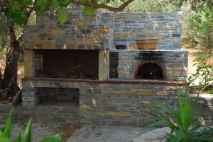 a brick building with a fire place in it at Faros in Milopotamos
