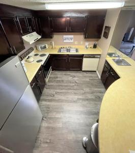 a kitchen with wooden cabinets and a stainless steel refrigerator at Sugar Top 2805 Condo in Sugar Mountain