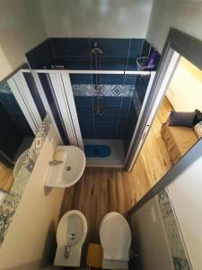 a bathroom with a shower and a toilet and a sink at Casa Liò in Santa Flavia