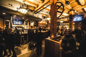 a crowd of people walking around a bar at Swans Brewery, Pub & Hotel in Victoria