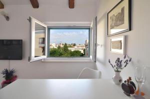 a white table with a window in a room at Apartment The Charm in Split