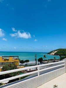 a view of the beach from the balcony of a building at Maravilhoso flat com vista para o Mar de Ponta Negra in Natal