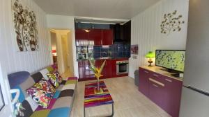 a living room with a couch and a kitchen at Les Gites Capra - Papaye in Bouillante