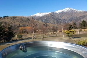 a view of the mountains from a hot tub at The Cottages at Lake Hayes in Queenstown