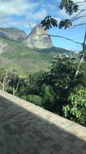 a mountain in the distance with a road and trees at Flat em Vista Azul Hotel in Pedra Azul