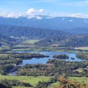 an aerial view of a lake in a valley at Pochotel Natural in Turrialba +4 photos