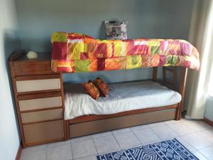 a childs bunk bed with a colorful blanket on it at Abrazo del Sol Villa Serrana. Lavalleja in Villa Serrana