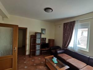 a living room with a couch and a window at Vila Cristal Costinesti in Costinesti