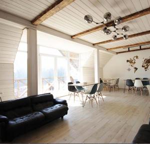 a living room with a couch and a table and chairs at Friends house bukovel in Bukovel