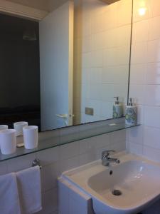 a bathroom with a sink and a mirror at A casa di Maurizio in Rosa Marina