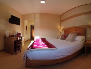 Ένα ή περισσότερα κρεβάτια σε δωμάτιο στο Abete Bianco - Albergo del Natale