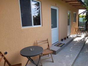 a patio with a table and chairs next to a building at Casa Elena in Corbu +9 photos