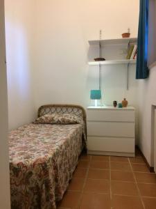 a small bedroom with a bed and a dresser at A casa di Maurizio in Rosa Marina