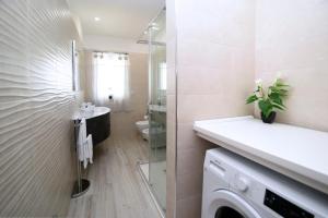 a bathroom with a sink and a washing machine at Residenza Oltremare in Peschici +19 photos