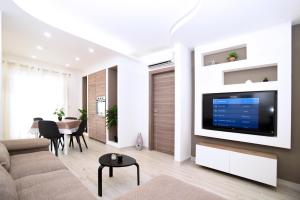 a living room with a flat screen tv on a wall at Residenza Oltremare in Peschici