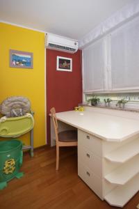 a kitchen with a desk and a chair in a room at Apartment Bizjak in Pula