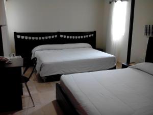 Postel nebo postele na pokoji v ubytování Hotel Suite Continental