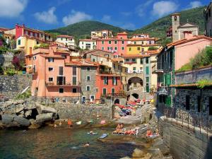 a group of people in the water near a town at Atena in La Spezia