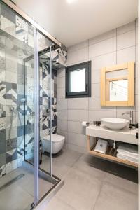 a bathroom with a glass shower and a sink at Marajo Suites in Skala Potamias