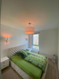 Posteľ alebo postele v izbe v ubytovaní Apartament Swing