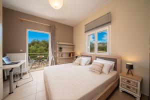 a bedroom with a bed and a balcony at Cicada Home in Karavádhos