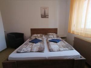 1 dormitorio con 2 camas con almohadas azules en Family House en Eger