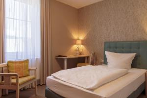Postel nebo postele na pokoji v ubytování Hotel Ettrich & Elbresort Rathen