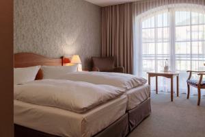 Postel nebo postele na pokoji v ubytování Hotel Ettrich & Elbresort Rathen