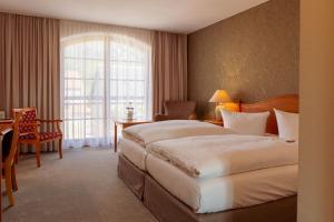 Postel nebo postele na pokoji v ubytování Hotel Ettrich & Elbresort Rathen