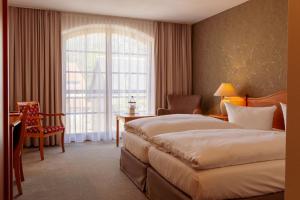 Postel nebo postele na pokoji v ubytování Hotel Ettrich & Elbresort Rathen