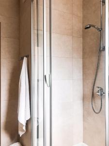 a shower with a glass door in a bathroom at Willa Pod Skocznią in Karpacz
