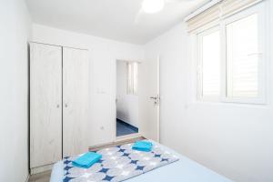 a white room with a bed and a window at Apartment & Rooms Alan in Dubrovnik