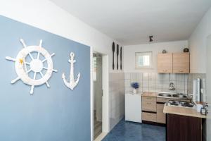 a kitchen with a nautical sign on the wall at Apartment & Rooms Alan in Dubrovnik