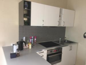 a kitchen with white cabinets and a counter top at Oslo Center in Oslo