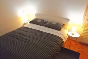 a bedroom with a large bed with two pillows at Apartment The View Costabella no.2 in Rijeka