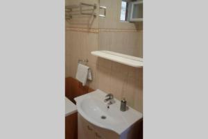 a bathroom with a sink and a mirror at Apartment The View Costabella no.2 in Rijeka