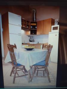 a kitchen with a table with two chairs and a refrigerator at Bruno in Bale