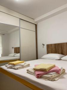 a bedroom with two beds and a large mirror at Apartment Jadran in Perast