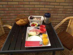 a tray of food on a table with a plate of food at B&B Nobel in Buren