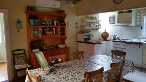 a kitchen with a table and a kitchen with a table and chairs at Delightful Cottage in Queenscliff