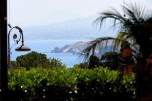 a view of a large body of water with a lamp at Baglio Dello Zingaro in Scopello