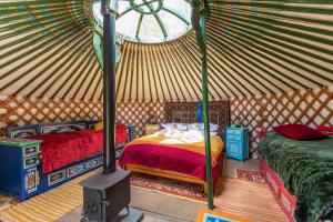 a room with two beds in a yurt at Pembrokeshire Yurts - Badger in Llanfyrnach
