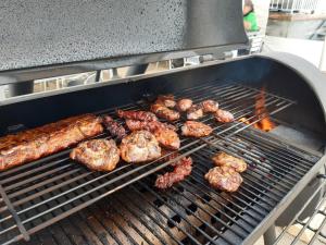 a bunch of meat and sausages cooking on a grill at Gasthaus Gemsli in Nesslau
