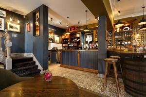 a bar in a pub with a counter and a table at Inn in the Park in Bournemouth