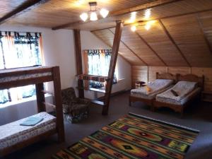a bedroom with two bunk beds and a rug at Guest House Mansarda in Yaremche