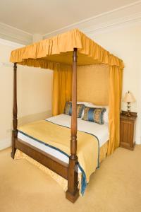a bedroom with a bed with a canopy at Springkell in Eaglesfield