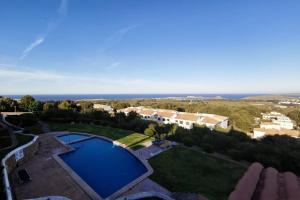 an aerial view of a villa with a swimming pool at V. Lona: beautiful duplex with a stunning seaview in Es Mercadal