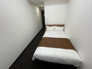 Postel nebo postele na pokoji v ubytování Ueno Urban Hotel Annex